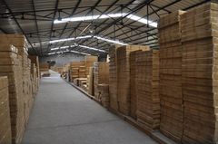 Boxed cabinets stored on warehouse racks